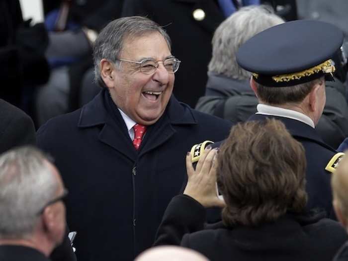 Outgoing Defense Secretary Leon Panetta makes a jovial entrance on to the platform.