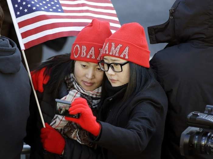 Two Mongolian tourists wait for Obama