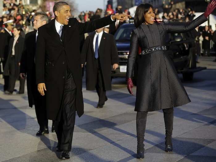 The First Couple waves at supporters along the parade route.