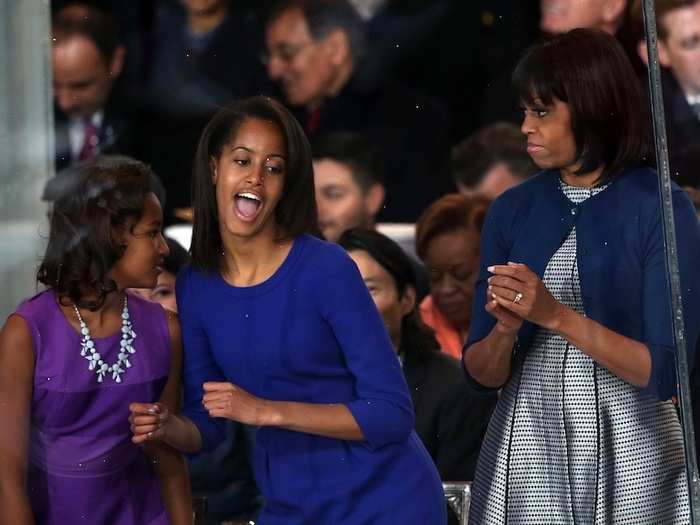 Malia Obama charms the crowd with her dance moves during the Inaugural Parade. The First Lady looks surprised.