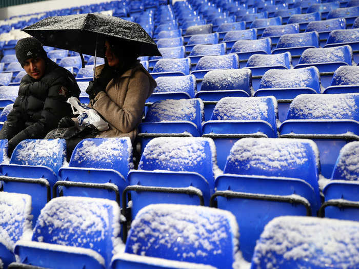 The crowd had to clear the snow off the seats themselves