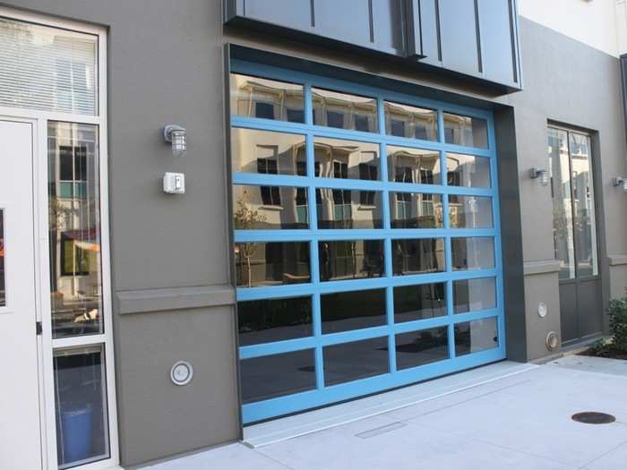 These garage doors roll up, allowing product teams assembled in temporary war rooms to spill out into the courtyard.