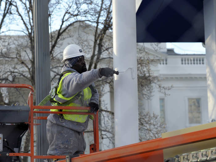 Workers are also putting fresh coats of paint on everything, like this flag pole near the reviewing stand.