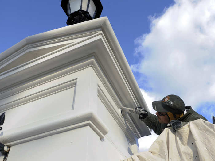 An entrance post outside the White House gets a last minute touch up.