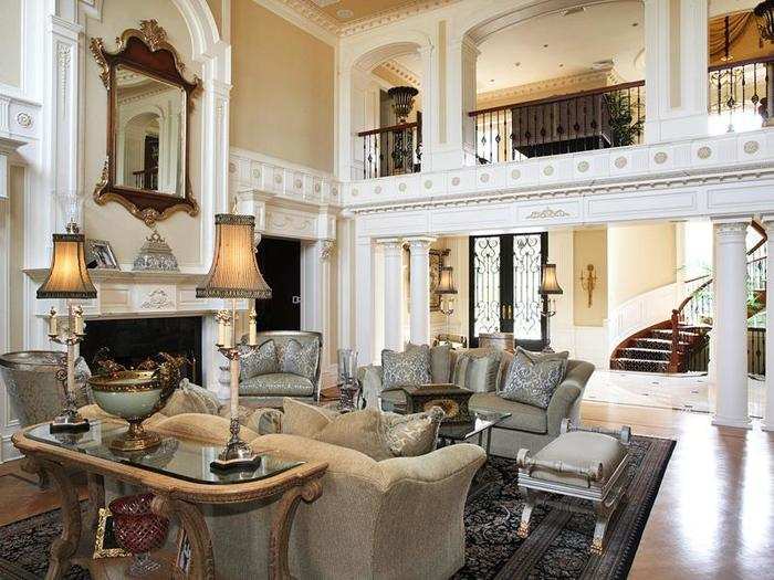 Every detail in the two-story living room is done with precision, from the crown moldings to the carvings on the fireplace.