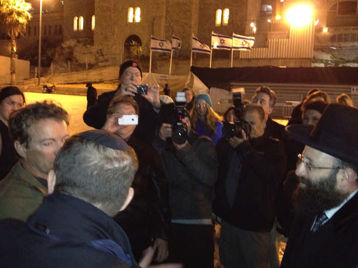 Israeli reporters crowd around Paul as he meets with Western Wall Rabbi Shmuel Rabinovitch.