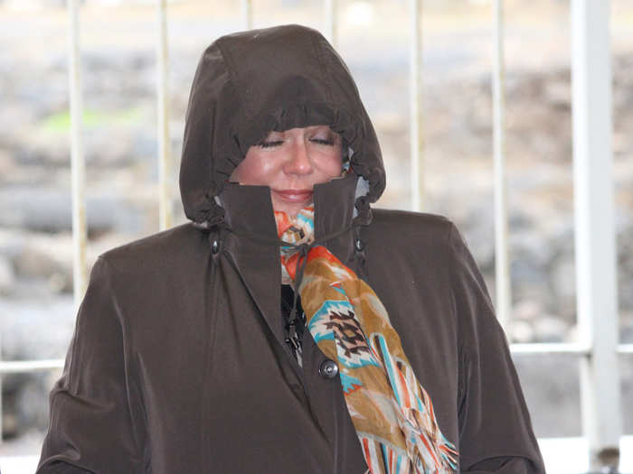 Kim Bengard, a prominent social conservative activist, shields herself from the cold.