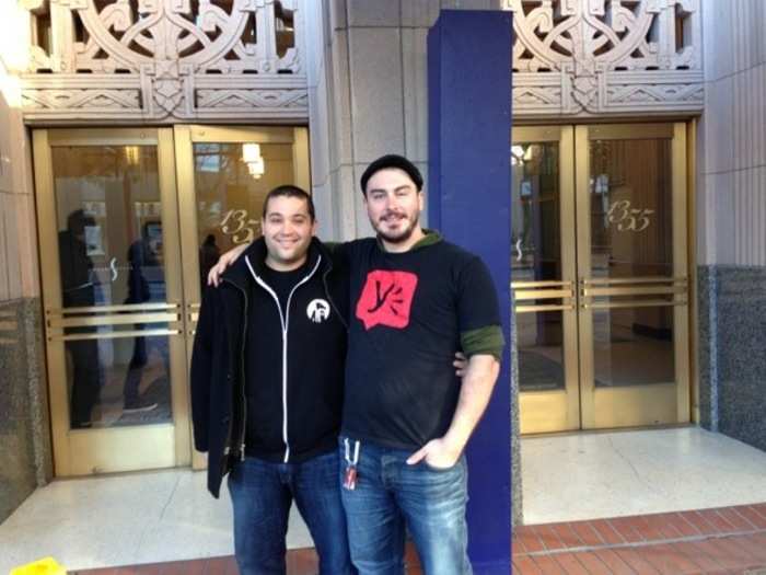 Yammer engineers Ben Freeman and Alex Annese in front of their new office. The red-and-black "Y," a reverse of Yammer