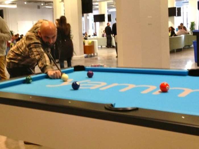 Pisoni tries out a new pool table decked out in Yammer blue.