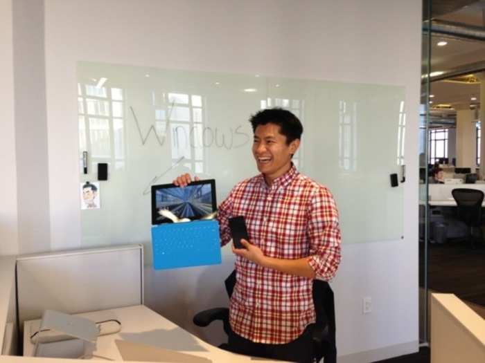 The big "Windows" sign caught our eye. A Microsoft incursion? Not really: Tuong La is on the engineering team for Windows clients. Here, he shows us his Surface RT tablet and Windows Phone.