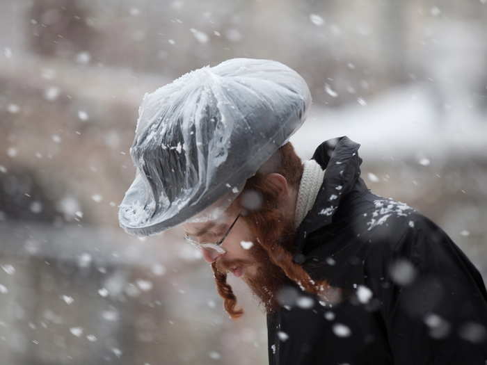 An Orthodox Jewish man walks in the snow in the Mea Shearim religious neighborhood