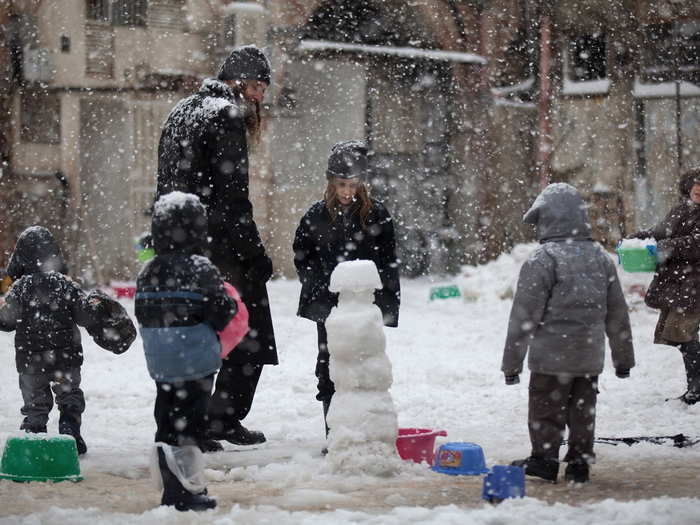 Jewish family plays in the snow