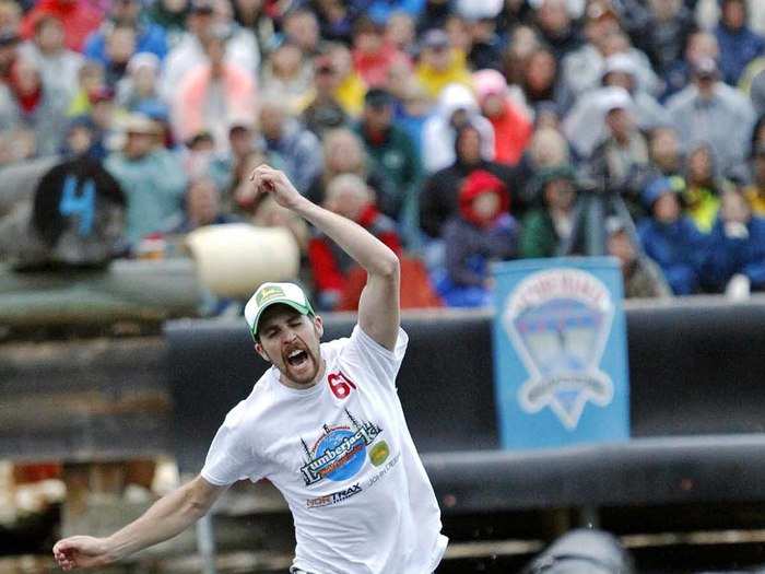 Marcel Scott of Barrington, Nova Scotia falls into the water during the men