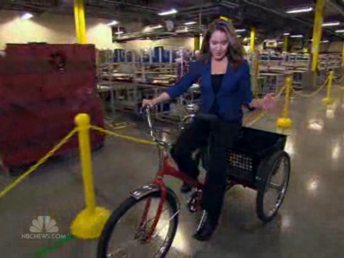 Amazon employees ride on tricycles to get to faraway items.