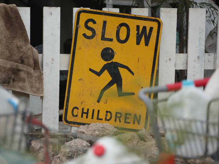 And a road sign serves as decoration beside the ubiquitous water bottles that residents haul in from the neighboring marina.