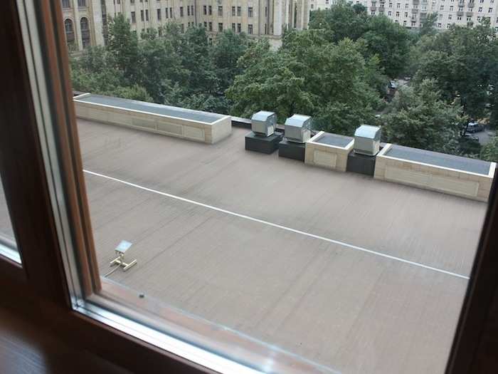 The window offers a view of the roof deck.