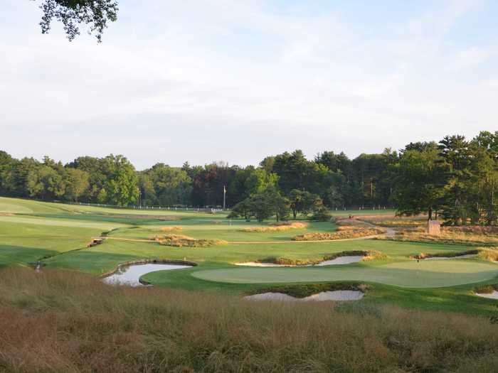 The East course at Merion Golf Club in Ardmore, Pennsylvania, was designed by Hugh Wilson in 1912. The host of the 2013 U.S. Open, the inland course has contoured fairways and angled greens.