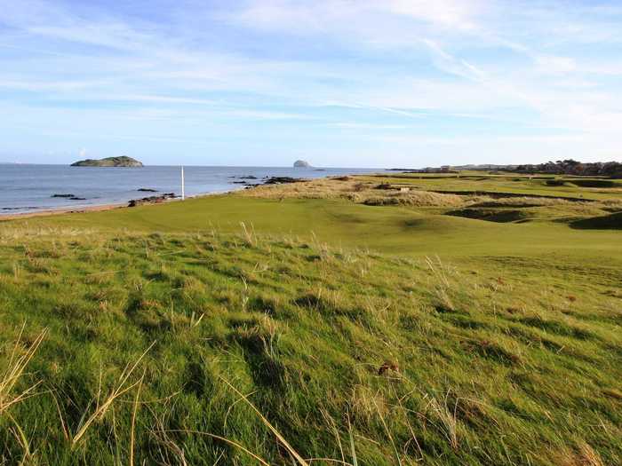 North Berwick in East Lothian, Scotland, has amazing views and an excellent collection of holes. A relatively short rough aims to keep rounds at no more than three hours. The 15th hole "Redan," a par-three measuring 190 yards, is the most copied hole in golf.