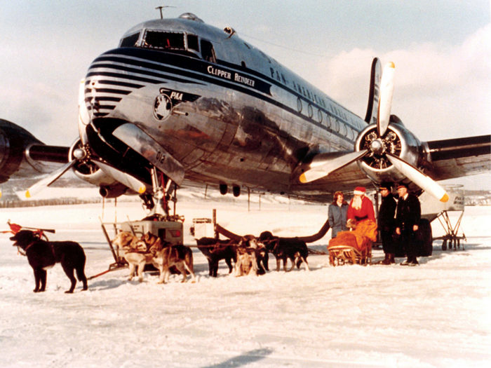 December 1946 - Santa and his sled-dogs chat with a DC-4 Crew in Fairbanks, Alaska.