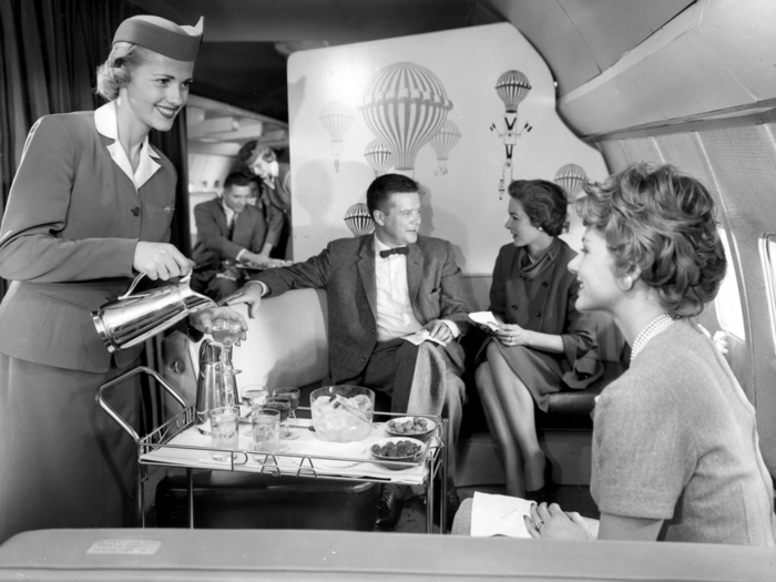 A Pan Am stewardess serves ice water and olives aboard the Boeing 707 (date unknown).