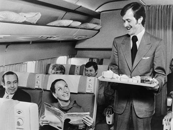 April 15, 1972 - a 26-year-old male flight attendant (a rare bird) offers a passenger her choice of beverages on a flight over Chicago.