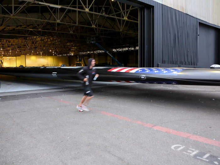 Once the hull is out, the 131-foot rigid wing sail follows.