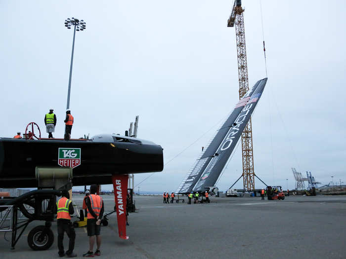 Pushed out beneath a crane, the crew secures a hook to the 3,0000 pound wing and it slowly lifts into the air.