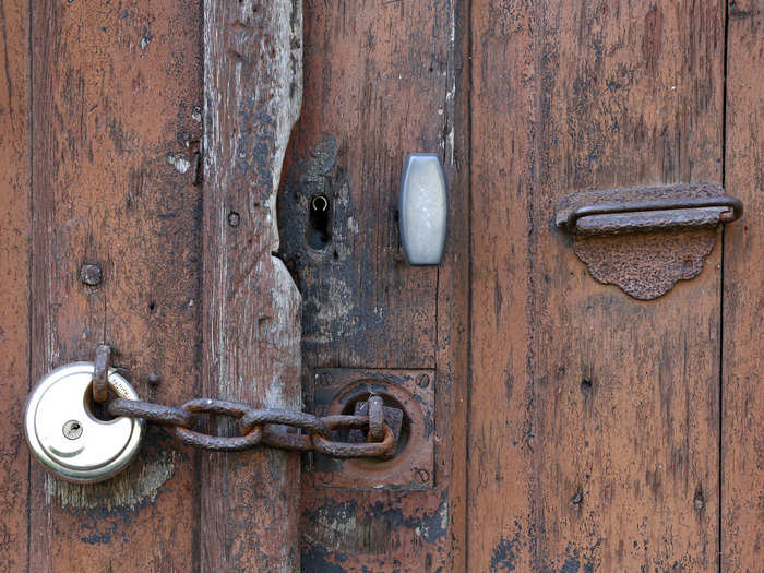 A lock and a chain secures one of the access gates to a house in Goussainville — perhaps the resident plans to return someday.