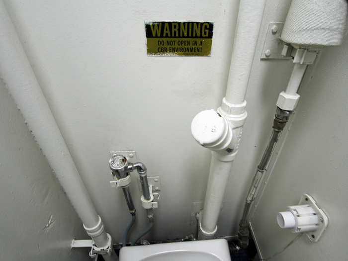 In the male head, or restroom, is a reminder of what the crew knows at all times: the Barry is designed for war. In a chemical/biological/radiological (CBR) environment, not even the toilet can be used.