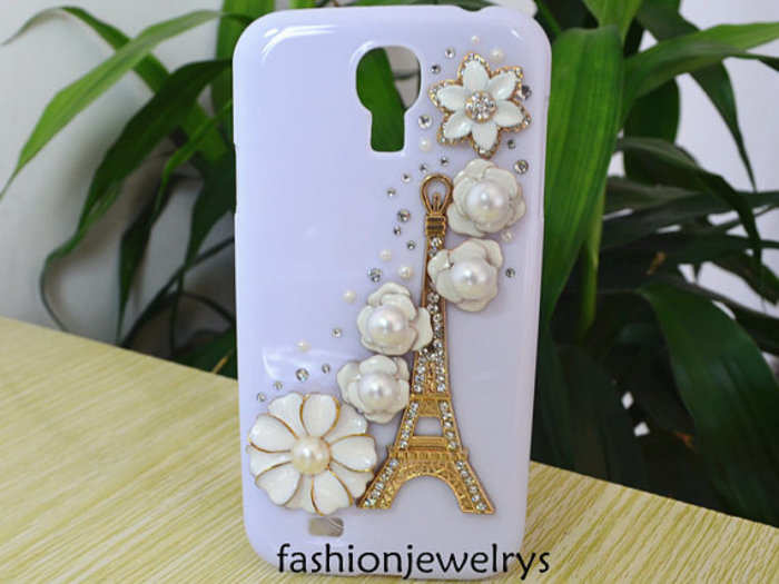 The Tower Flower - $1,495. This case, found on Etsy, is a hard plastic shell hand-decorated with crystals and rhinestones in a "Paris in the spring" motif. It