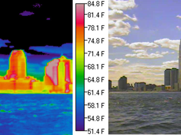 In this thermal image of the Jersey City skyline, the Hudson River is relatively cool (blue) while the buildings are relatively warm (red). The water temperature changes little in response to the daily cycle in heating, while temperatures of building surfaces rise and fall over a day. Clear portions of the sky are very cold (black) while the low-altitude clouds have temperatures similar to the river.