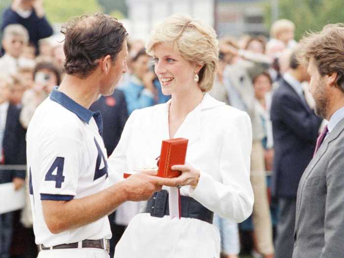 The Princess of Wales presents her husband with a prize after he played in an England-Chile polo match.