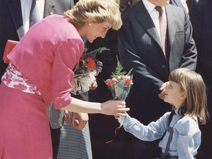 The internationally adored princess receives flowers from a young girl during a trip to Madrid.