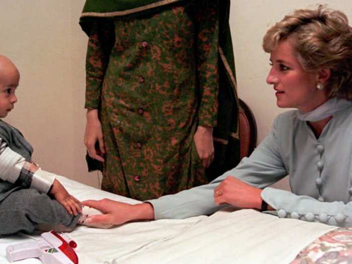 A young cancer patient reaches out to the Princess during her tour of a Pakistani hospital.