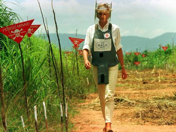 The Princess walks with the Red Cross in one of the safety corridors of the Angola land mine fields.