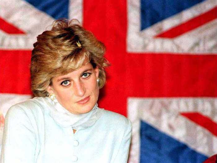 Princess Diana sits in front of a British flag during a visit to a cancer hospital in Lahore.