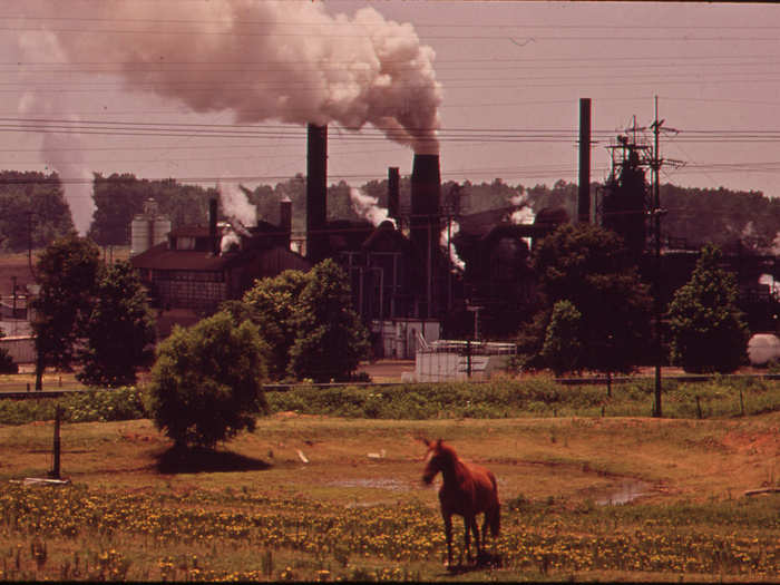 The Atlas Chemical Company Belches Smoke across Pasture Land in Foreground. The Plant Is Referred to as "Old Darky" in the Community Because Black Soot from the Plant Covers Everything Near-By. One Farmer Claims He Lost Several Cows Due to Soot and Chemicals from Atlas, 06/1972
