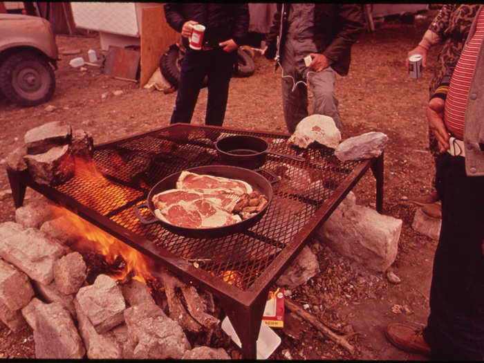 Deer Hunters Prepare Their Evening Meal at the Permanent Camp They Have Constructed near Wild Deer Feeding Places. They Construct Blinds near the Feeding Places and Slaughter the Animals When They Come for Food, 11/1972