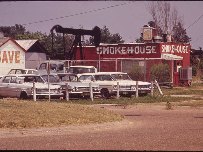 Oil Derrick beside Restaurant and Used Car Lot, 06/1972