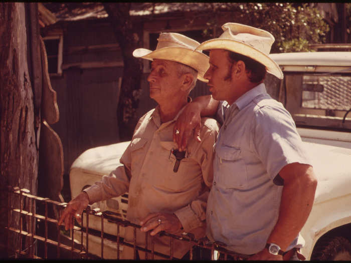 Father and Son Who Own One of the Ranches in the Leakey Texas, and San Antonio Area Watch as Sheep Are Sheared, 05/1973