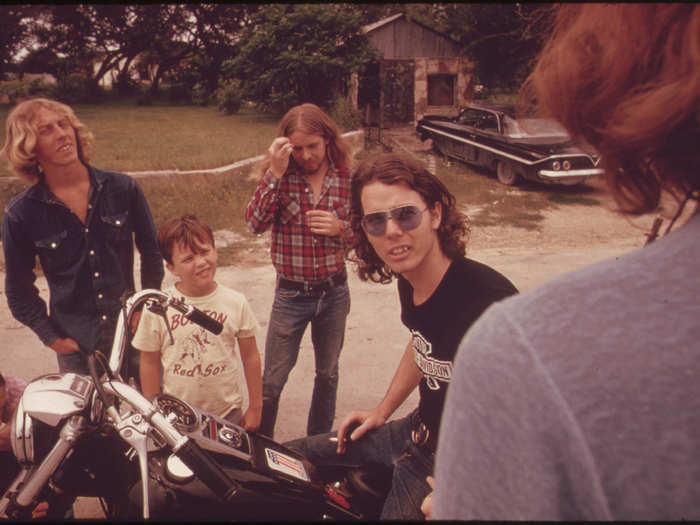 Motorcyclist from Leakey, Texas, Stops to Talk with Friends near San Antonio, 05/1973