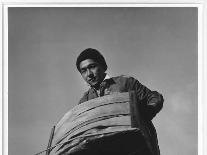 Here, Tsutomu Fuhunago lifts a produce crate.