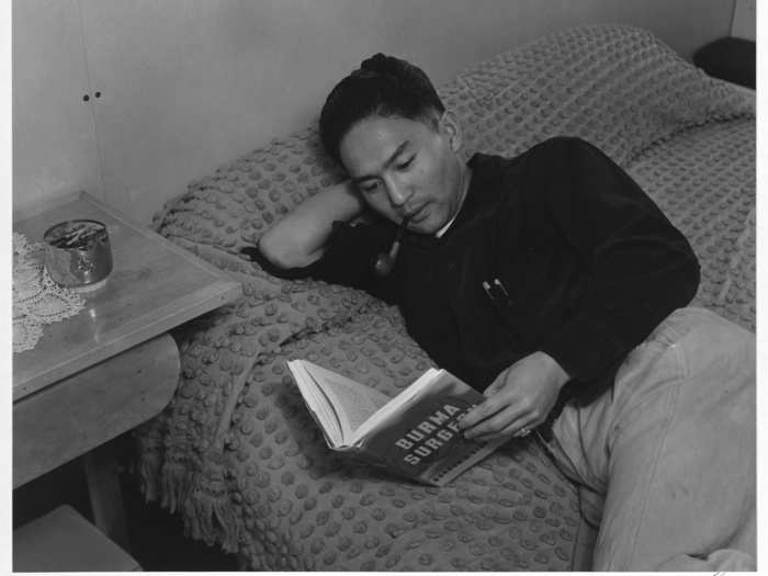 Adams also captured the recreational time at the camp, like in this image of Dennis Shimizu lying on his bed reading.