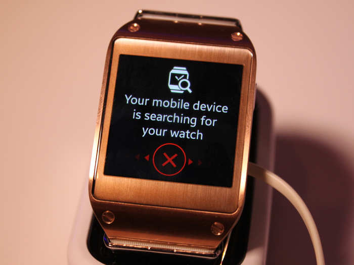 Whoa! The Galaxy Gear starts buzzing and beeping like crazy. That should make it easy enough to find. Swipe across that red "X" to stop the noise.