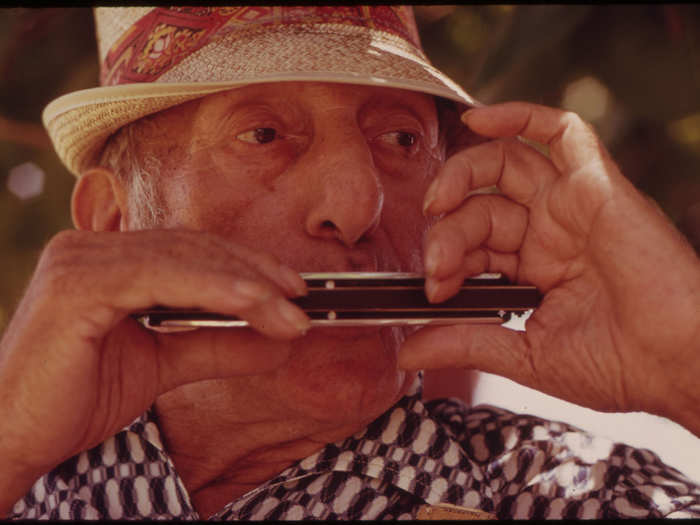 Resident of a Retirement Hotel in South Beach with Harmonica. (Miami Beach)