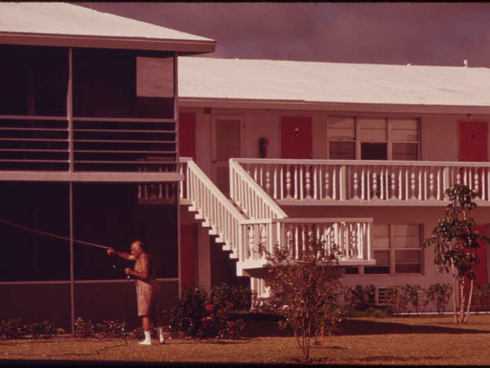 A Resident of the Century Village Retirement Community Watering the Flowers in Front of His Apartment. All Units in the Complex Are Individually-Owned Condominiums. (West Palm Beach)