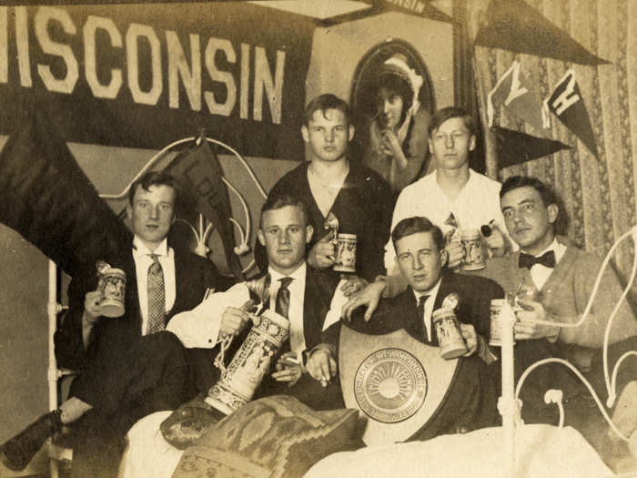 Male students raised a glass in a boarding house or fraternity in this 1909 photo.