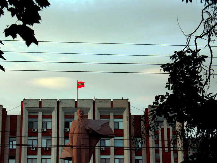 The green and red flag of Transnistria flies in the sunset.