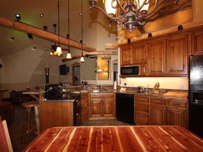 Guests can dine in the eat-in, state-of-the-art kitchen with a large fridge, granite countertops, microwave, oven, stove, and even a spice rack.