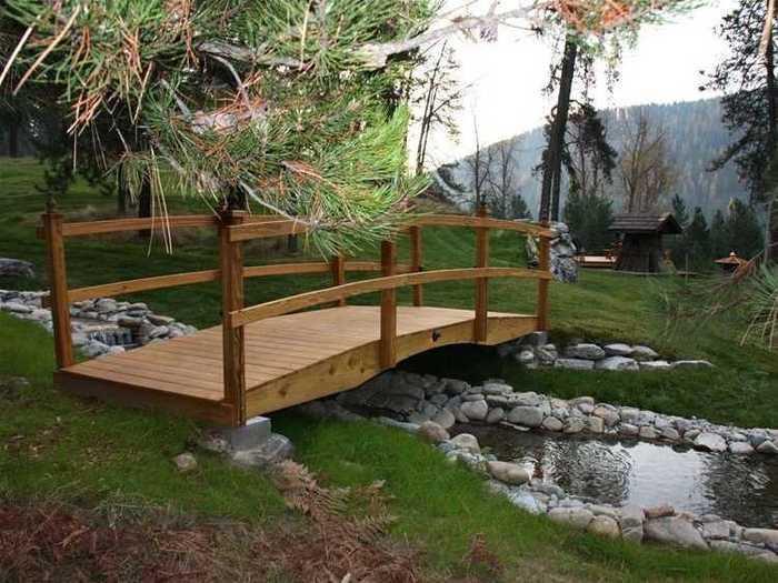 The waterfall feeds the bubbling brook. You can cross over by way of the Troll Bridge...